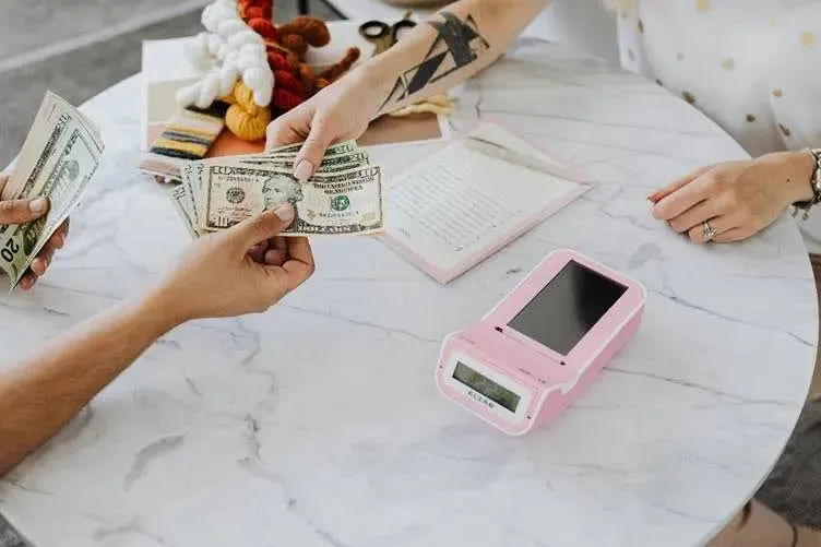 hands-holding-us-dollar-bills.webp